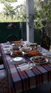 a table with a platter of food on it at Monara Backpacker Inn Unawatuna in Unawatuna