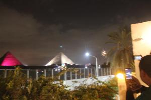 a view of a building at night with pyramids at Farida Pyramids Boutique Hotel in Cairo
