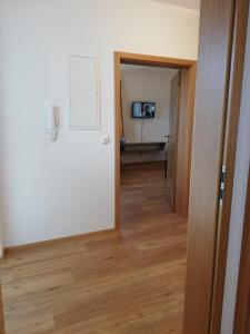 a hallway with a door and a television in a room at Ferienwohnung Anton Künzler in Riezlern