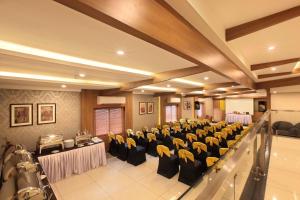 a banquet hall with tables and chairs in a room at Hotel Samrat in Taliparamba