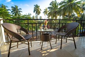 two chairs and a table on a balcony at Mariners Bay Suites in Calangute