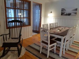 a dining room with a table and a chair at Mäntyniemi in Petäjävesi
