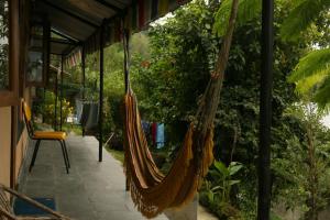 a couple of hammocks hanging from a porch at peace guesthouse cottage in Pokhara