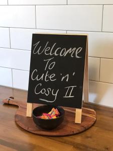 a sign that says welcome to office exay next to a bowl at Cute and Cosy II - Events, Workers, Getaways. in Murray Bridge
