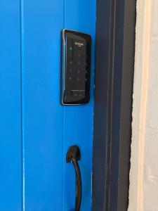 a remote control is attached to a blue door at Cute and Cosy II - Events, Workers, Getaways. in Murray Bridge