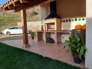 a patio with an outdoor oven in a house at Casa rural Quinta de los Almiares in El Raso