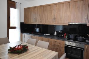 a kitchen with a wooden table with a centerpiece on it at Katsaros - Elegant Home in Nafplio in Ária