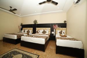 Rúm í herbergi á Hotel Ragavendra Rameswaram