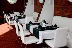 a white table topped with white chairs and a white table cloth at Porto Riva in Zaporozhye