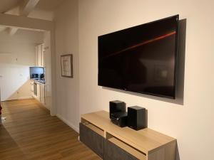 a living room with a large flat screen tv on a wall at FeWo Herrmann in Petersdorf auf Fehmarn