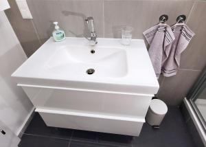 a bathroom with a white sink and a toilet at Herzlich Willkommen - Küss die Hand in Vienna