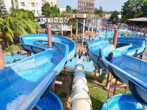 a group of water slides at a water park at CT Homestay at Lagoon Park Resort in Melaka