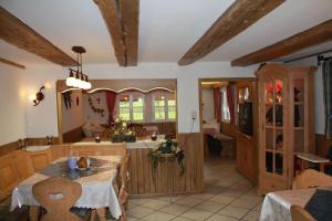 a kitchen with wooden cabinets and a table and chairs at Hansenchristenhof in Gutach
