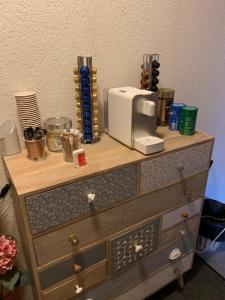 a wooden dresser with a toaster on top of it at Do mi si la do re in Dorénaz