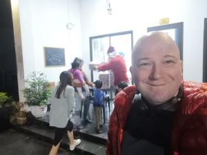 a man smiles at the camera with a group of people at Coto Center Homestay in Đảo Cô Tô +171 photos