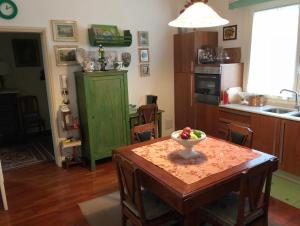 a kitchen with a table with a bowl of fruit on it at Casa di Anna in Ravenna