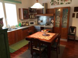 a kitchen with a table with a bowl of fruit on it at Casa di Anna in Ravenna