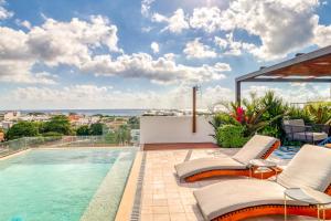 a villa with a swimming pool and a patio at Sunset 203 at Riva in Playa del Carmen
