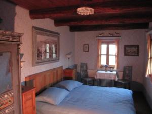 a bedroom with a bed and a table and a window at Cottage on Hill in Donja Stubica