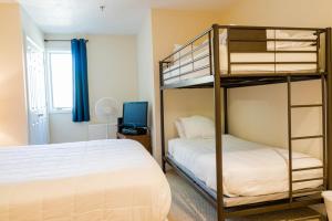 a bedroom with two bunk beds and a bed at Vantage Point Villas at Stratton Mountain Resort in Stratton Mountain