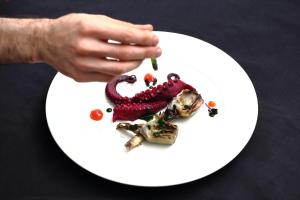 una persona comiendo un plato de comida en una mesa en Hotel Du Soleil en Rímini