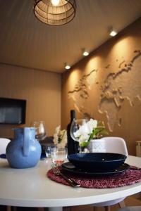 a table with a plate and a world map on the wall at MaSà Appartamenti (Il Mare in Salotto) in Pescara