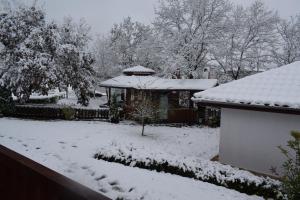 a yard covered in snow with a gazebo at Two Villas Kirkovo in Kirkovo