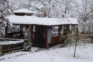 a house covered in snow with a fence at Two Villas Kirkovo in Kirkovo