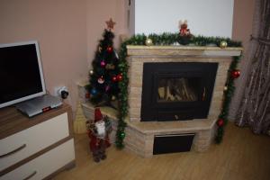 a living room with a christmas tree and a fireplace at Two Villas Kirkovo in Kirkovo