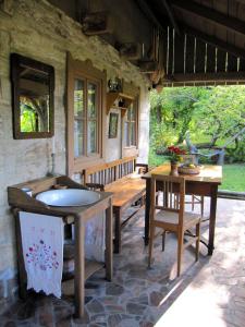 a room with two tables and a bench in a house at Cottage on Hill in Donja Stubica