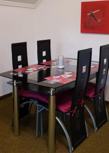 a dining room table with four chairs around it at Giselas Haus in Cloppenburg
