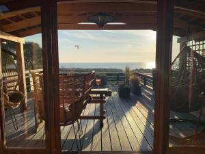 a porch with a bench and a view of the ocean at Normandia in Kuźnica