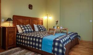 a bedroom with a bed with a table on it at Guest house LAUKMALI in (( Falcgrāve ))