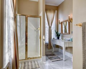 a bathroom with a shower and a sink at Prairie Guest House in Fishers