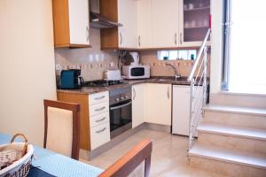 a kitchen with a sink and a stove top oven at António B in Alvor