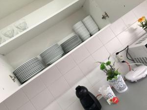a kitchen with white walls and white tiles at Sunset House Azores in Ponta Delgada +31 photos