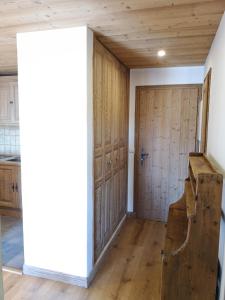 a room with wood paneling and a wooden door at Chalet Les Combes in Notre-Dame-de-Bellecombe