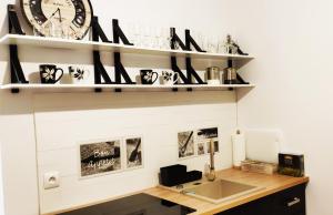 a room with a desk and a clock on the wall at Apartament Centrum in Malbork