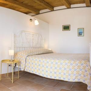 a bedroom with a bed and a side table at Agriturismo Rosa Antica in Monte San Vito