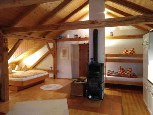 a living room with a wood stove in a attic at Ferienwohnung Lackenhäuser in Neureichenau