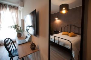 a bedroom with a bed and a desk with a laptop at la Dimora del Borgo in Fiumicino