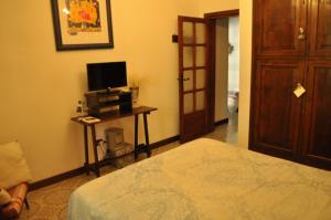 a bedroom with a bed and a television on a table at Villa Parco Alta Murgia in Cassano delle Murge