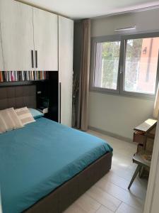 a bedroom with a bed and a desk and a window at 8 di cuori in Rimini