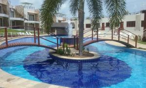 a bridge over a swimming pool with a fountain at Condomínio Brisas do Amor in Pipa