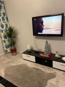 a living room with a flat screen tv on a wall at Apartament w Stolicy Podhala in Nowy Targ