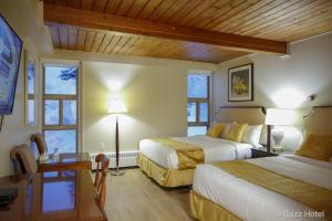 Postel nebo postele na pokoji v ubytování Grizz Hotel