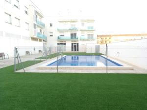 une piscine en face d'un bâtiment dans l'établissement Apartamentos Blaucel, à Deltebre