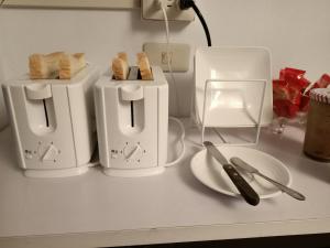 two toasters on a counter with bread on a plate at 七十腳落背包客棧 in Green Island