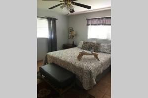 a bedroom with a bed and a table at Tranquility in Paradise - Cudjoe in Summerland Key