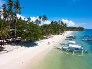 an aerial view of a beach with boats in the water at Pyramid Resort in Panglao Island